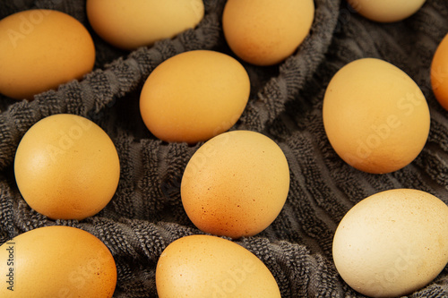 Brown chicken eggs on grey cloth, farm products, natural eggs.