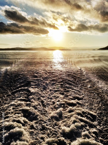 Sunset over ferry wake