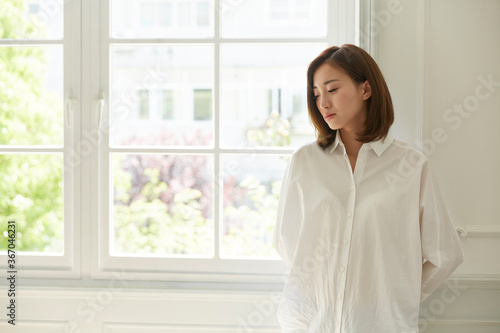 young asian woman staying at home looking bored and sad Free Download young asian woman staying at home looking bored and sad - GFXLoad