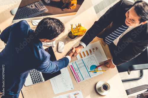 фотографія Group business people handshake at meeting table in office together with confident shot from top view