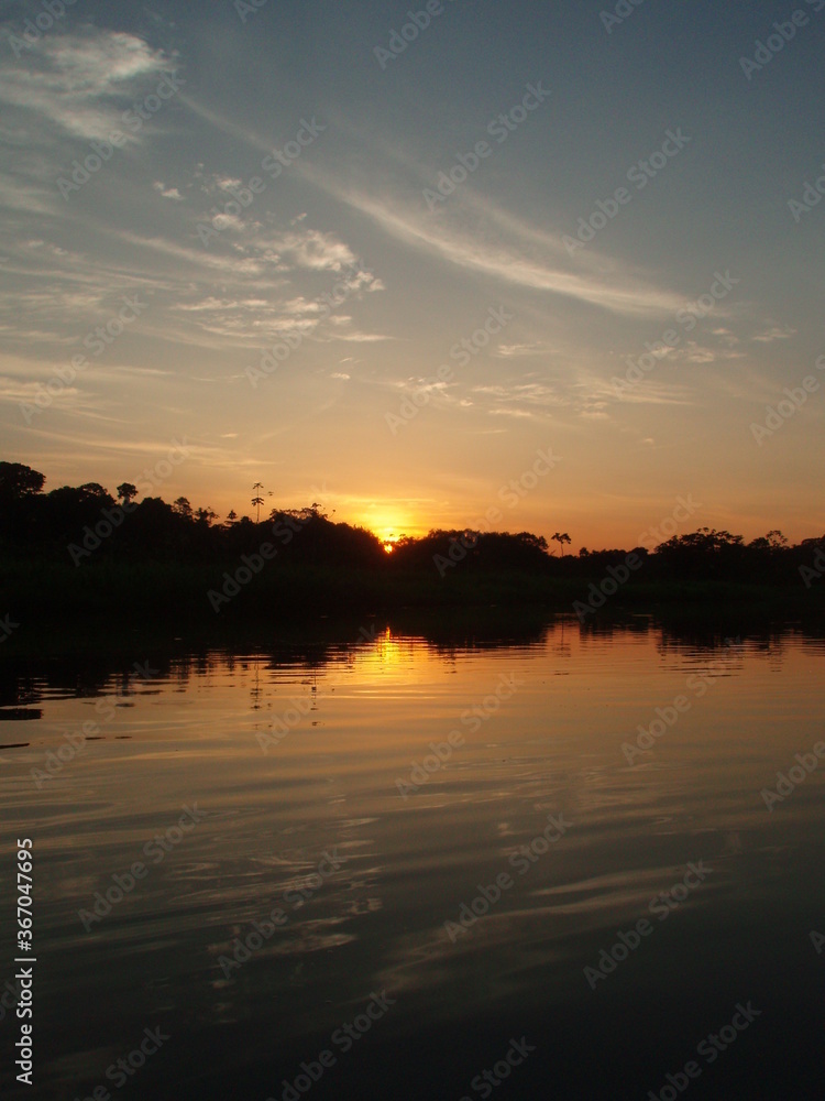 Sunset on a river deep in the Amazon rainforest of South America