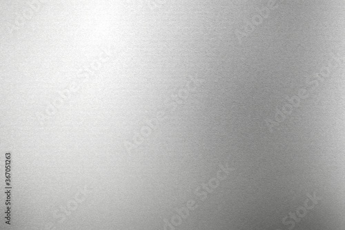 Glowing silver foil metal panel wall with copy space, abstract texture background