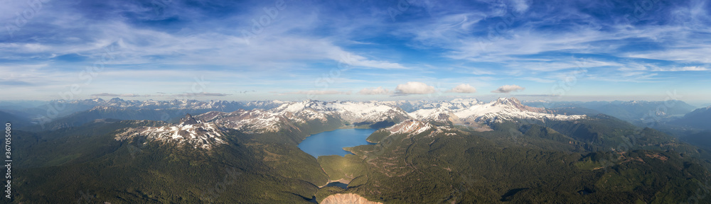 Aerial Panoramic View of Garibaldi surrounded by Beautiful Canadian Mountain Landscape during a sunny and cloudy day. Taken near Squamish and Whistler, North of Vancouver, British Columbia, Canada.