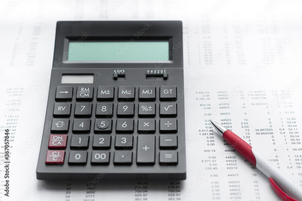 Financial activity, accounting, tax calculation or saving and investment, black calculator with pen Financial activity, accounting, tax calculation or saving and investment, black calculator with pen