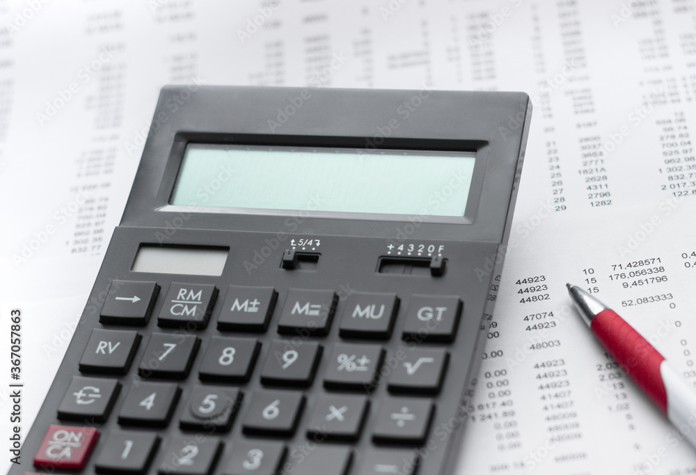Financial activity, accounting, tax calculation or saving and investment, black calculator with pen Financial activity, accounting, tax calculation or saving and investment, black calculator with pen