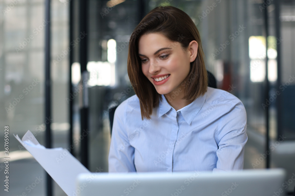 Happy entrepreneur woman sit at desk reading good news in post paper correspondence. Happy entrepreneur woman sit at desk reading good news in post paper correspondence.