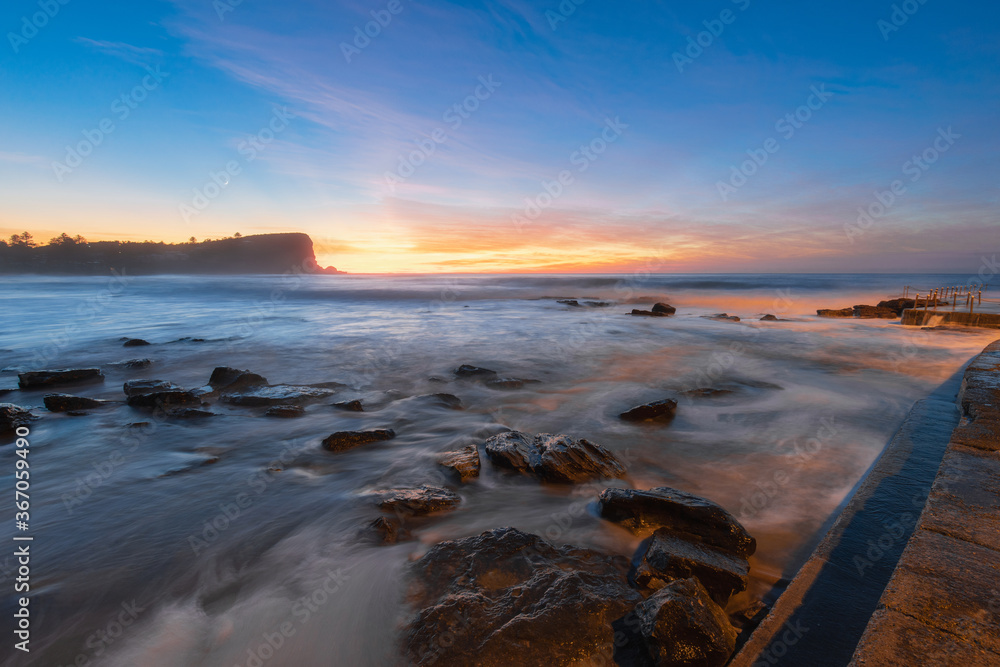 Dawn view at rocky beach coastline.