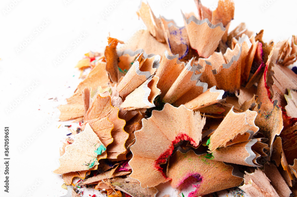 Shavings of red pencil in close-up on a white background. Pencil lead whole and broken on a white background. Leftovers from a pencil. Macro, a pile of shavings
