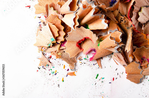 Shavings of red pencil in close-up on a white background. Pencil lead whole and broken on a white background. Leftovers from a pencil. Macro, a pile of shavings