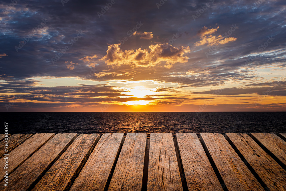 Old wooden table Brown grunge placed separately on a Sea view Sunset and rain clouds background For home decoration