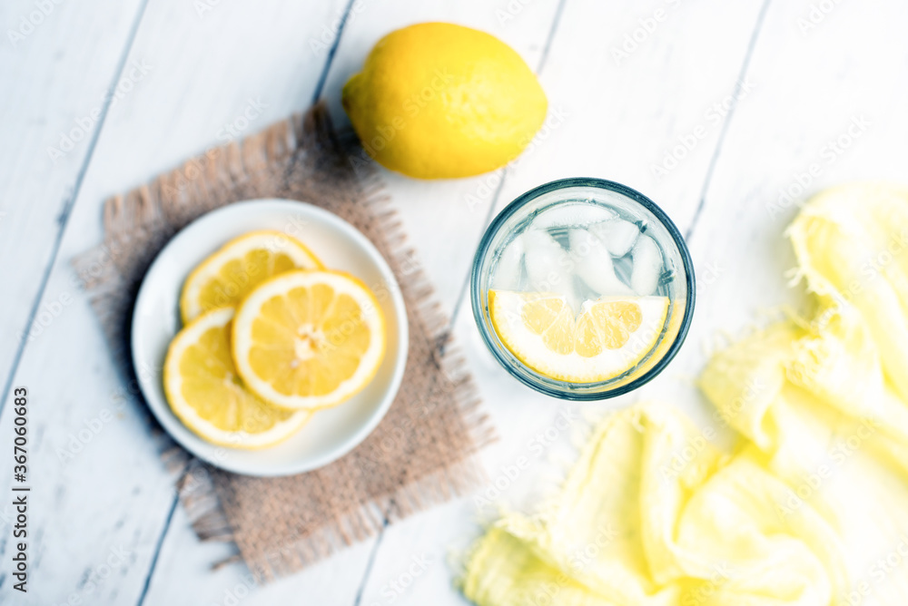 Cold Detox Water with lemon slices and mint on a white wood table Cold Detox Water with lemon slices and mint on a white wood table