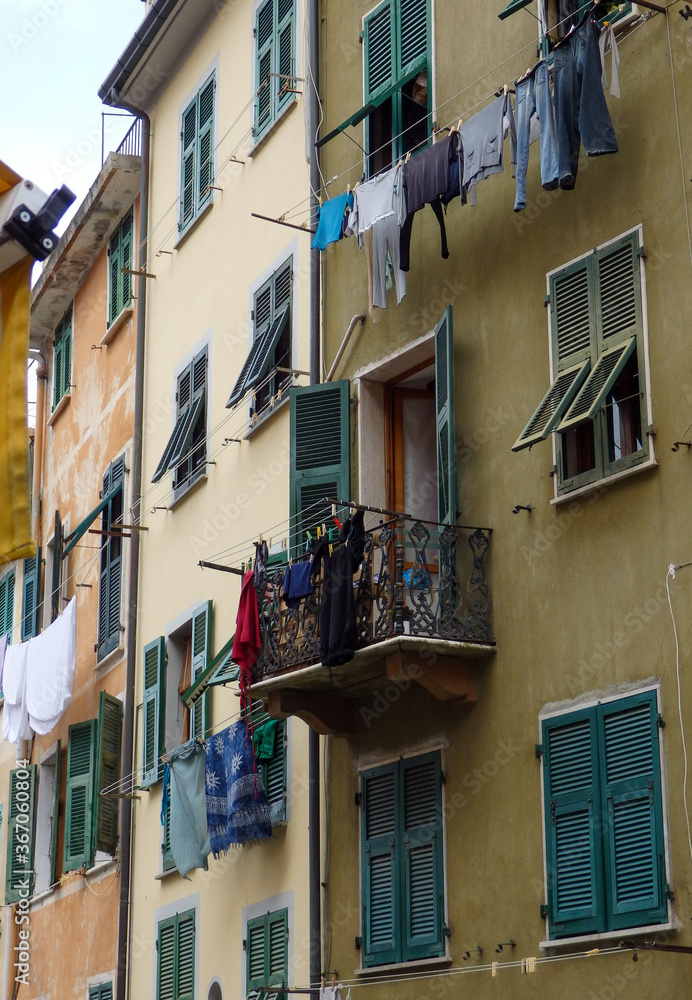 hanging laundry out the window and balcony to dry 
