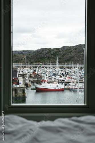Boats docked and framed by hotel window 