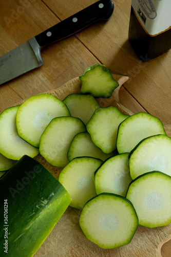 Organic zucchini slices on wooden table