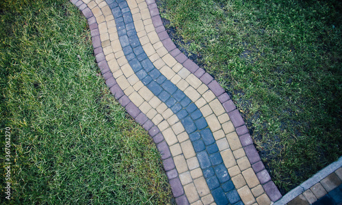 Perspective View Monotone Gray Brick Stone Pavement on The Ground for Street Road. Sidewalk, Driveway, Pavers, green grass