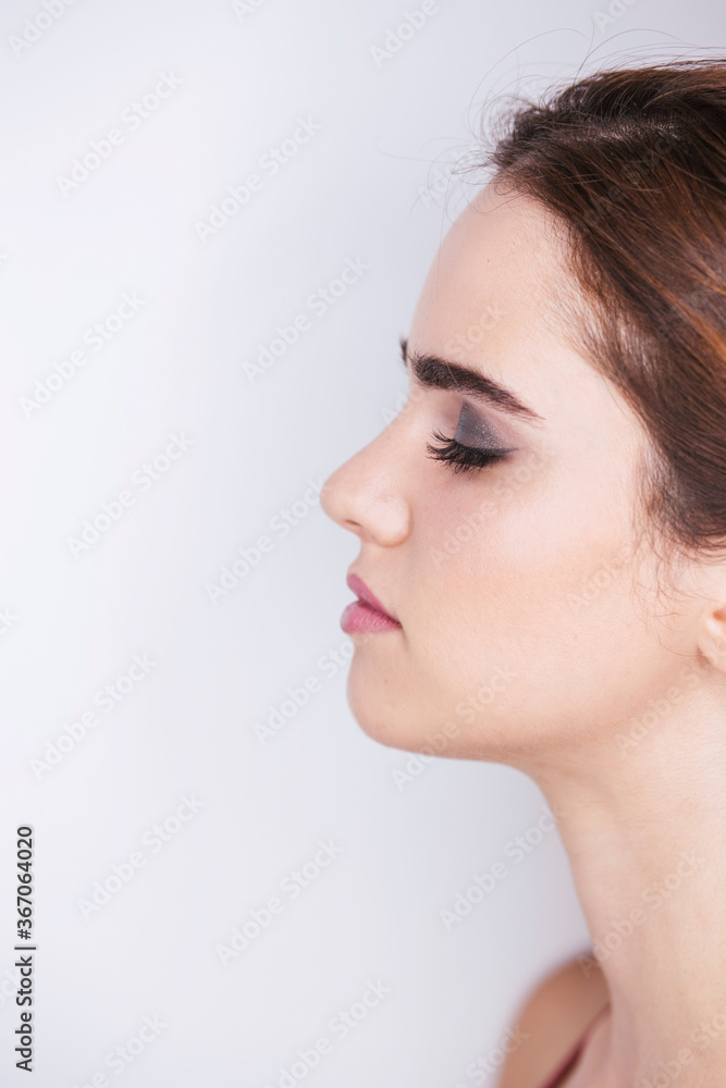 Obraz premium Portrait of a woman with make-up on a white background, make-up concept