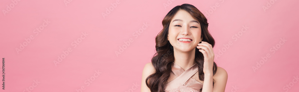 Asia beautiful woman wear pink dress. Standing in front of a pink background. Asia beautiful woman wear pink dress. Standing in front of a pink background.