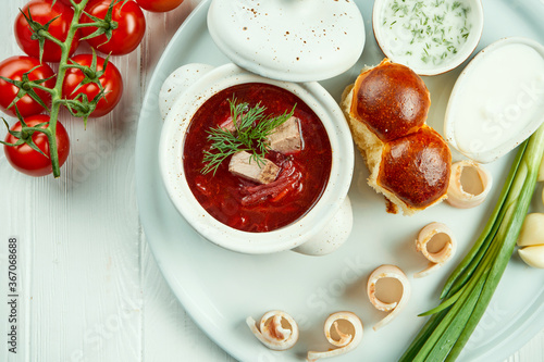 Classic Ukrainian borsch with meat, pamphlet and lard on a white background