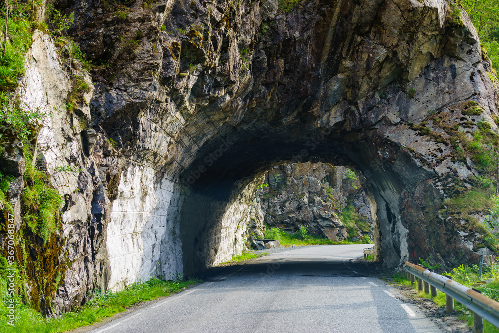 Road with tunnel in mountains Norway