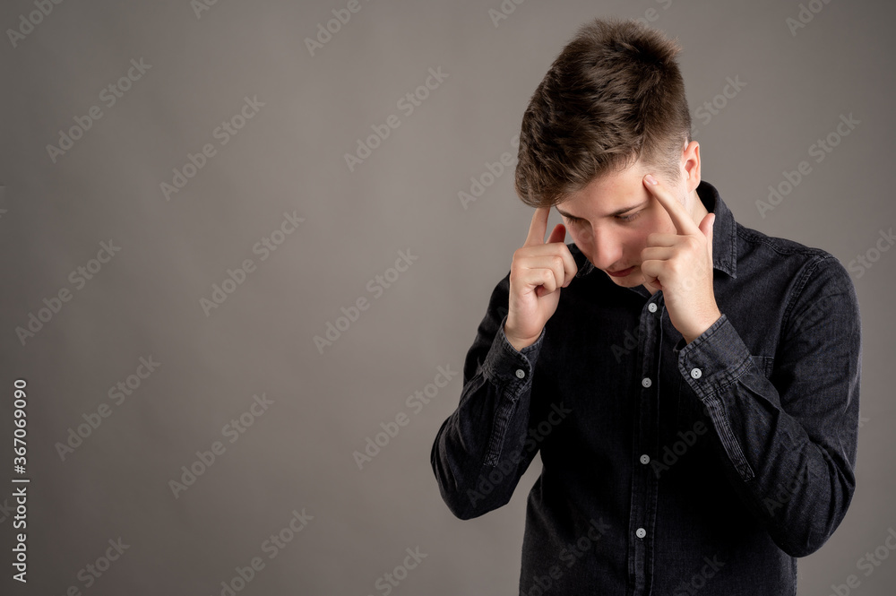 Portrait of serious stylish attractive man dressed with a casual black shirt making thinking gesture Portrait of serious stylish attractive man dressed with a casual black shirt making thinking gesture