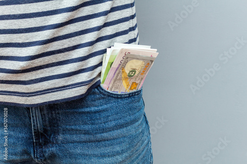 Lot of money, euro, dollar banknotes in the pocket close up