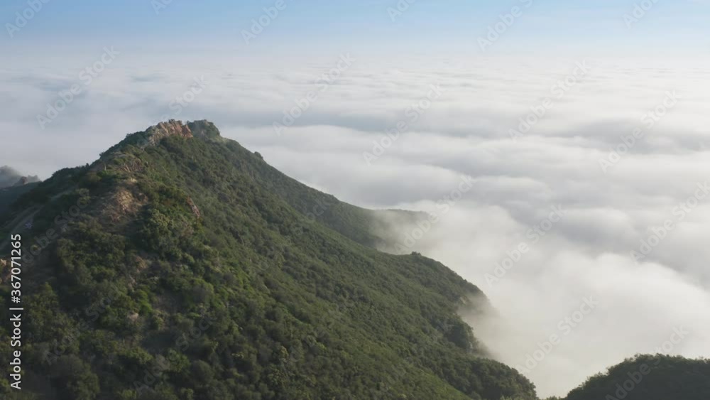 Beautiful cloudscape in the mountains. Magical white clouds floating under the the green peaks of high mountains. Cinematic aerial of magical skyline. Sun is highlighting the scenic landscape, 4K Beautiful cloudscape in the mountains. Magical white clouds floating under the the green peaks of high mountains. Cinematic aerial of magical skyline. Sun is highlighting the scenic landscape, 4K