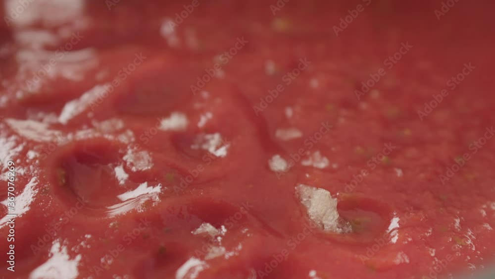 Slow motion smoked salt fall into tomato soup puree macro shot Slow motion smoked salt fall into tomato soup puree macro shot