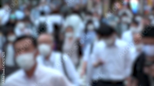 Wallpaper Mural TOKYO, JAPAN - JUL 2020 : Crowd of people at the street near Shinjuku station in rush hour. Commuters wearing surgical mask to protect from Coronavirus (COVID-19) in hot summer. Blurred slow motion. Torontodigital.ca