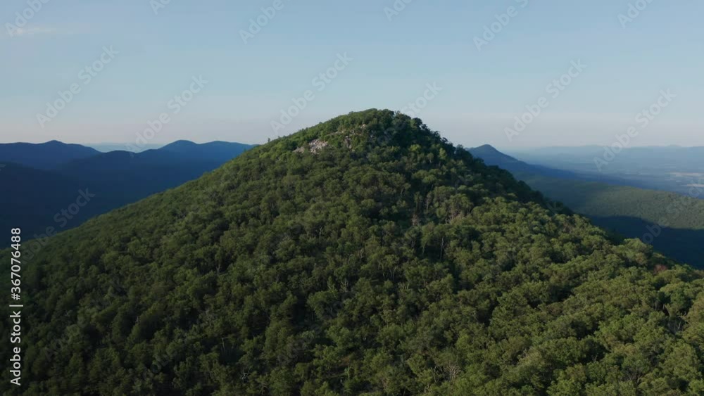 A dolly in, pedestal up aerial shot above Duncan Knob and Catback Mountain in the Massanutten Range in George Washington National Forest in Page County, VA. The Fort Valley is seen to the north. A dolly in, pedestal up aerial shot above Duncan Knob and Catback Mountain in the Massanutten Range in George Washington National Forest in Page County, VA. The Fort Valley is seen to the north.