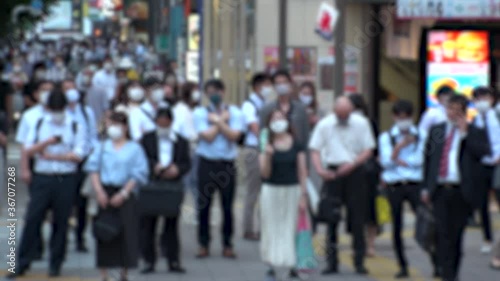 Wallpaper Mural TOKYO, JAPAN - JUL 2020 : Crowd of people at the street near Shinjuku station in rush hour. Commuters wearing surgical mask to protect from Coronavirus (COVID-19) in hot summer. Blurred slow motion. Torontodigital.ca