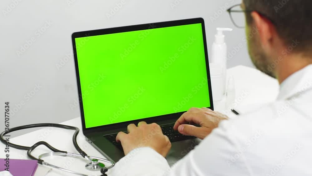 close-up of doctor using chromakey laptop while work close-up of doctor using chromakey laptop while work