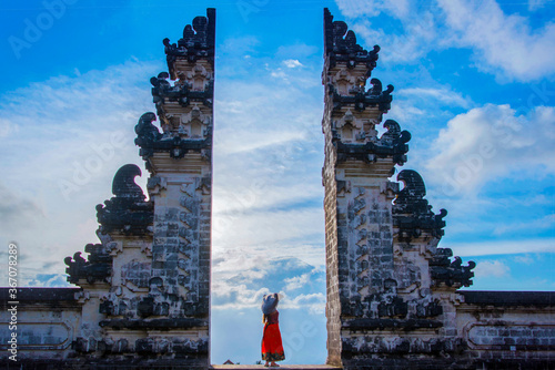 Girl standing on the portal of Lempuyang temple, Bali, Indonesia photo