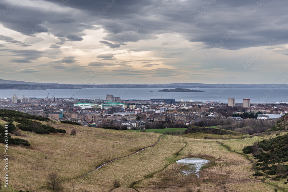 Aerial view with Hunters Bog in Holyrood Park also called Kings or Queens Park in Edinburgh city, Scotland, UK