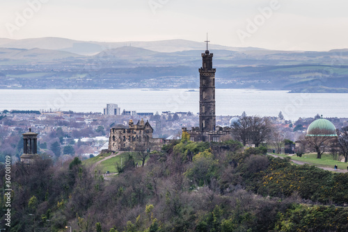 Monuments of Horation Nelson and Dugald Stewart on Calton Hill seen from Holyrood Park in Edinburgh city, Scotland, UK photo