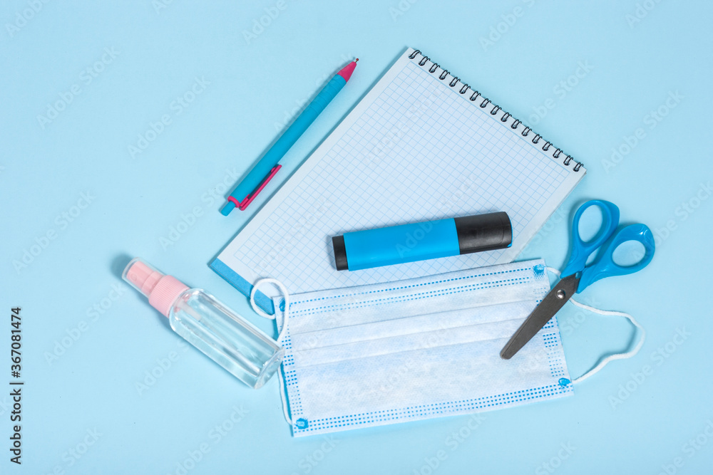 School stationery and medical masks on desk, keep your distance, open school, go back to school for the coronavirus pandemic after being infected 19 School stationery and medical masks on desk, keep your distance, open school, go back to school for the coronavirus pandemic after being infected 19