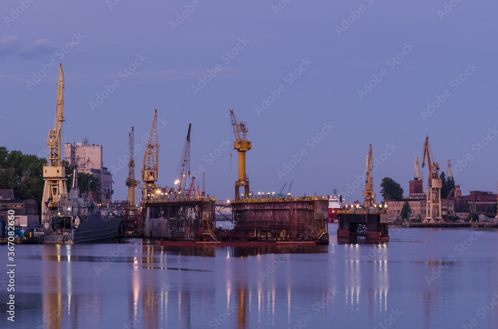 SHIPYARD - Harbor cranes and repair dock at dawn