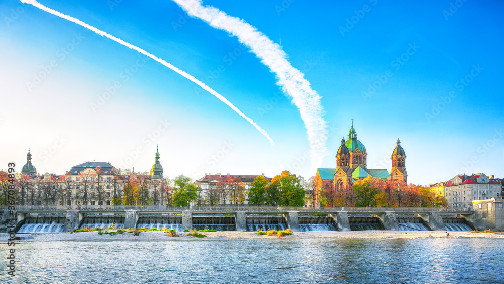 Fototapeta premium Fantastic autumn view on Saint Lucas Church (Lukas kirche), the largest Protestant church in Munich, and Isar River