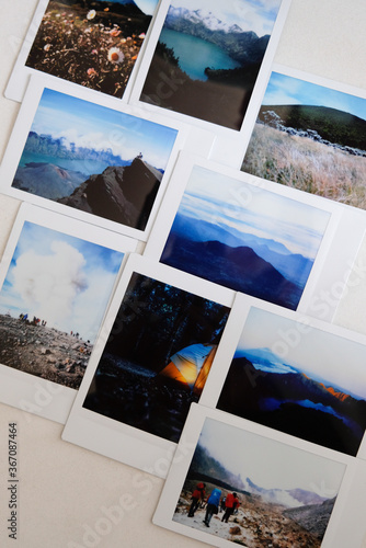 Some landscape polaroid photo laid out on a table.