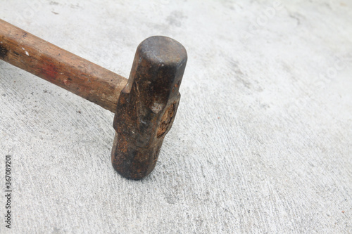 Old rusty hammer on dirty floor