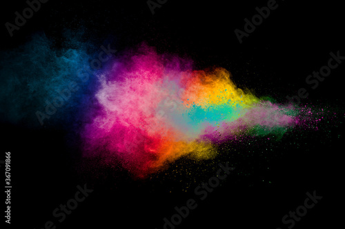 Explosion of colorful pigment powder on black background.Vibrant color dust particles textured background. © Pattadis