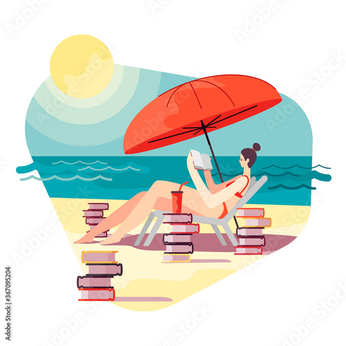 Young woman on the beach in sunny day is reading book under umbrella