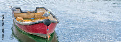 Fotografi Rowing boat moored in harbour, England