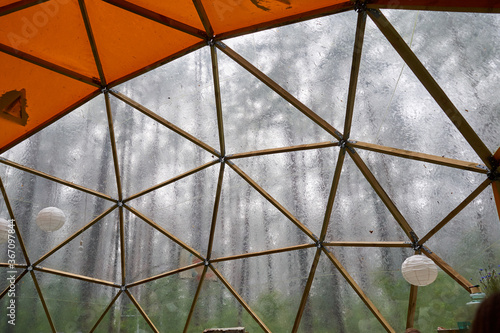 Wallpaper Mural Huge dome with wooden construction and transparent plastic on one side. Raining outside.  Torontodigital.ca