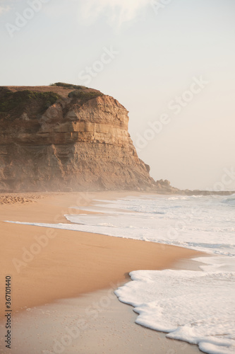 Foto Photo of a beach in Portugal with a cliff in the back