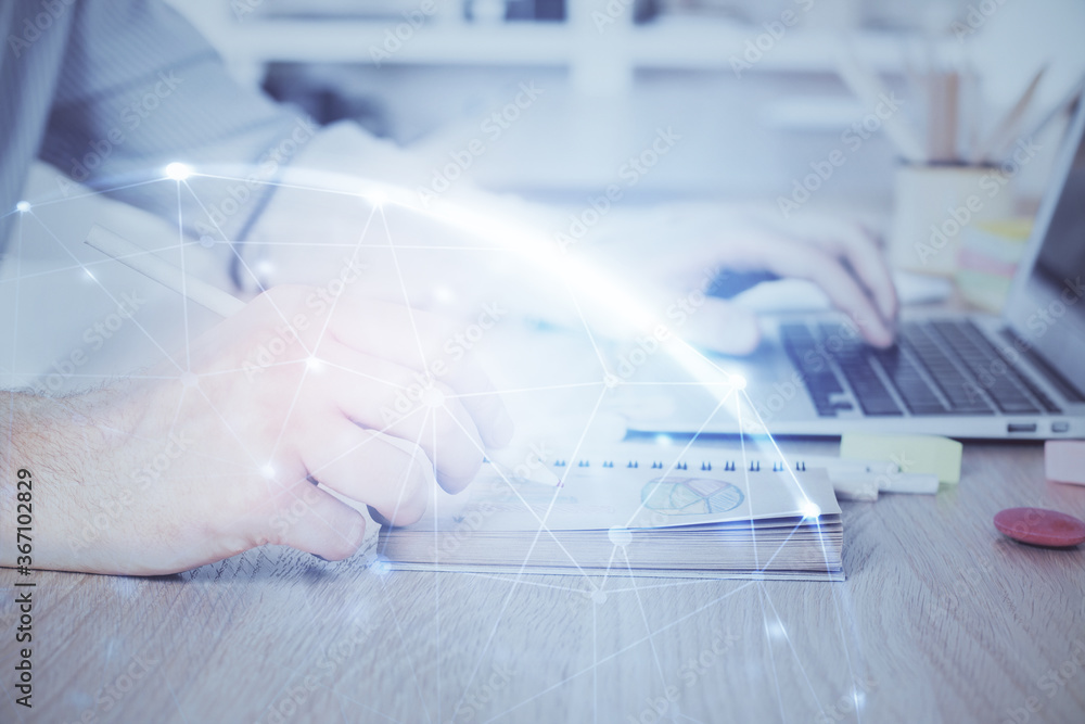 Fototapeta premium Social network theme hologram with businessman working on computer on background. Concept of world wide web. Multi exposure.