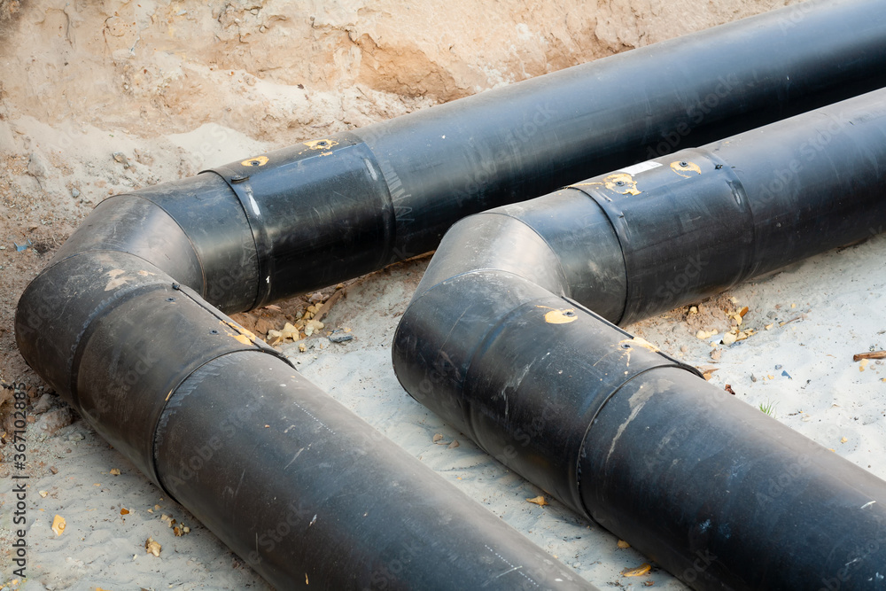 Replacement of the pipeline for the supply of hot water and heating to multi-storey buildings. There are two pipe lines in the trench. In the frame, the track is rotated by 90 degrees. Replacement of the pipeline for the supply of hot water and heating to multi-storey buildings. There are two pipe lines in the trench. In the frame, the track is rotated by 90 degrees.