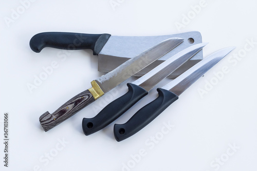A group of knives of different sizes on white ground,close up