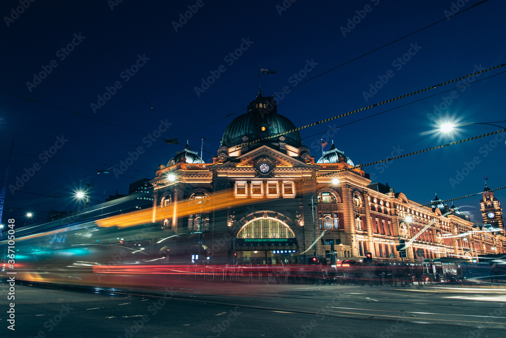 Fototapeta premium Heritage train station with tram passing in front of it 