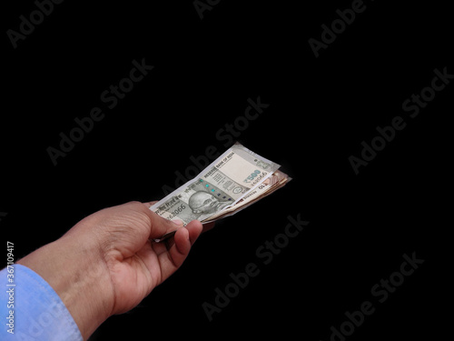 Indian Banknote in hand offering money Concept on back background