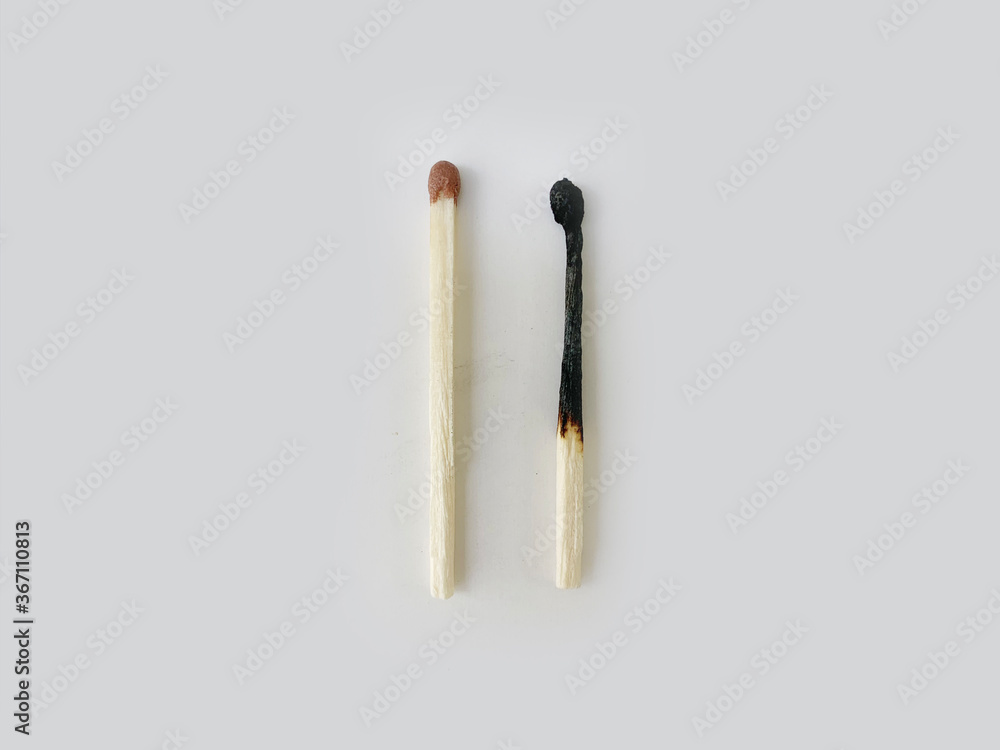 one whole and one burned match on a white background one whole and one burned match on a white background